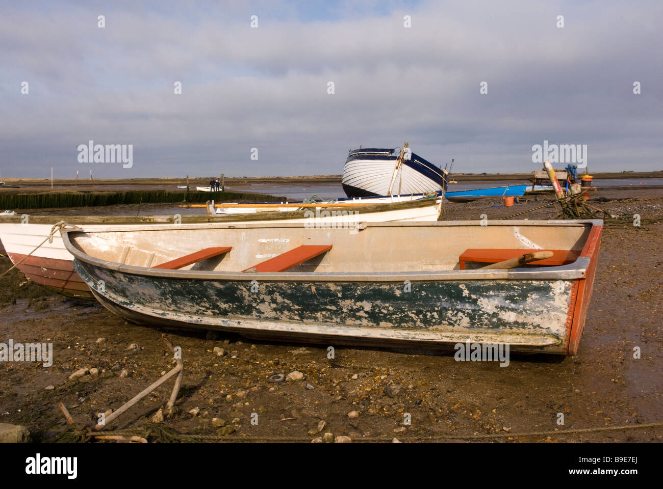 Fishing boats moored on the saltings salt marshes at Brancaster Staithe ...