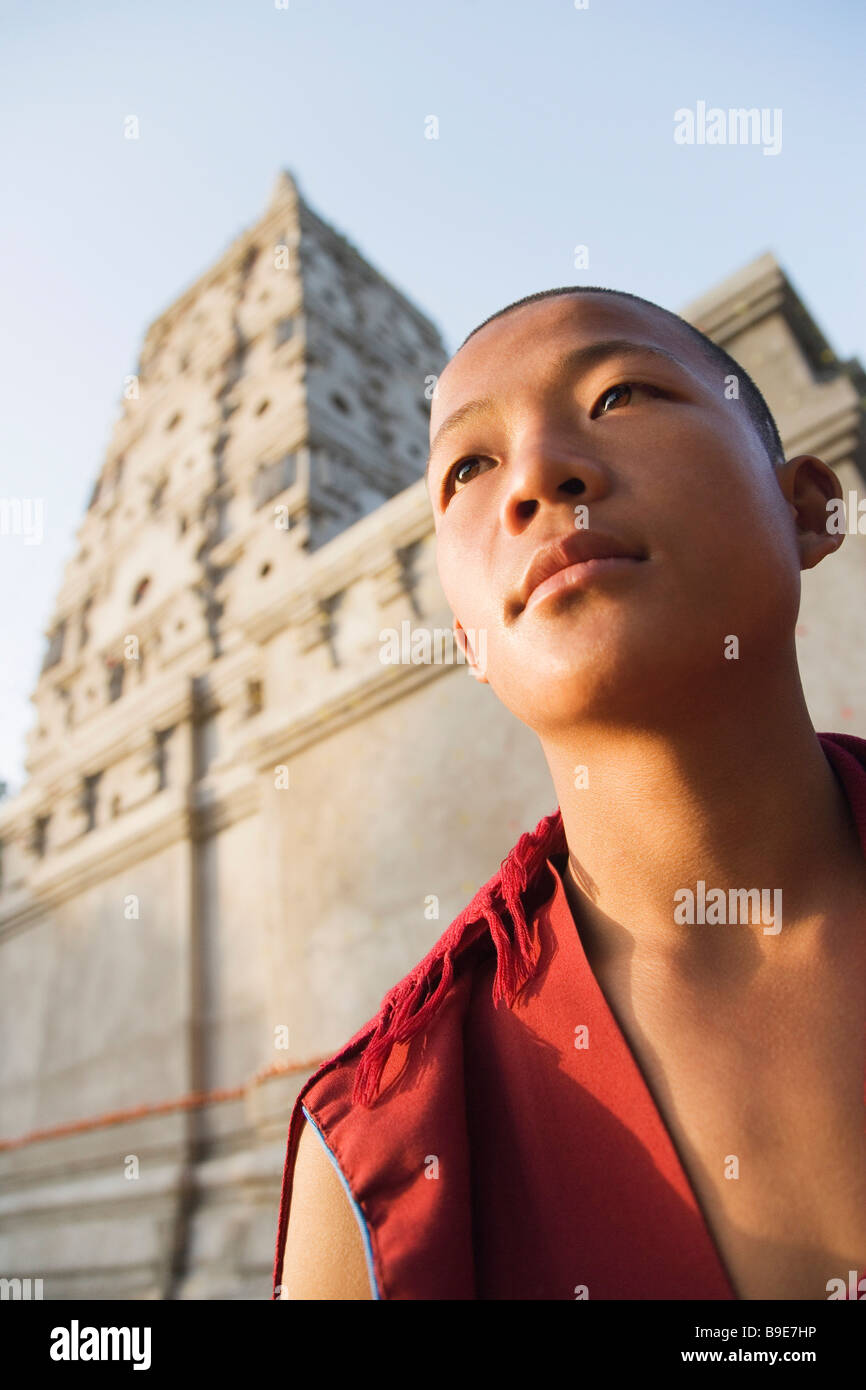 Monk day dreaming in front of a temple, Mahabodhi Temple, Bodhgaya ...