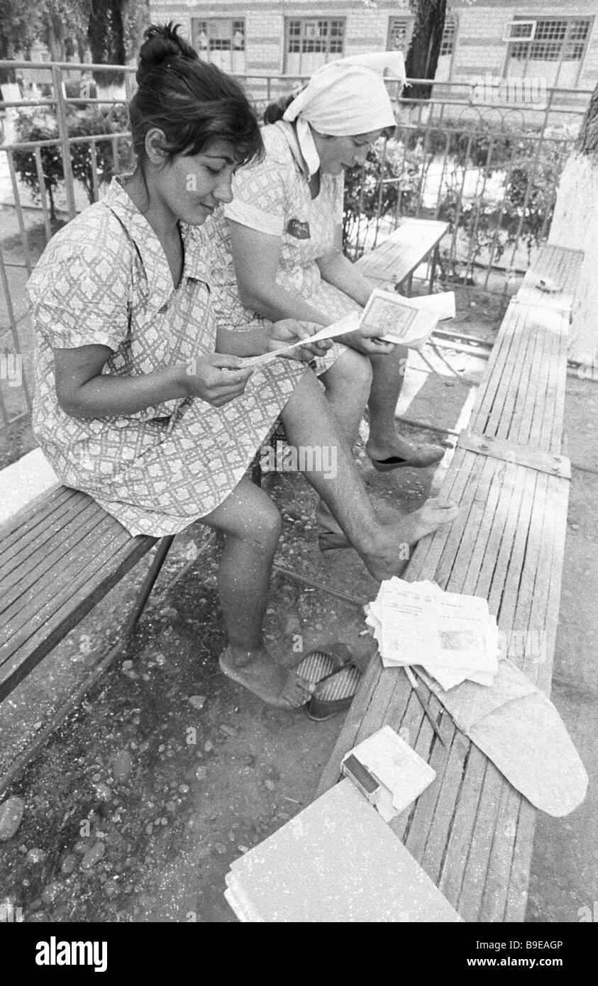 Women s prison inmates reading letters from home Stock Photo Alamy