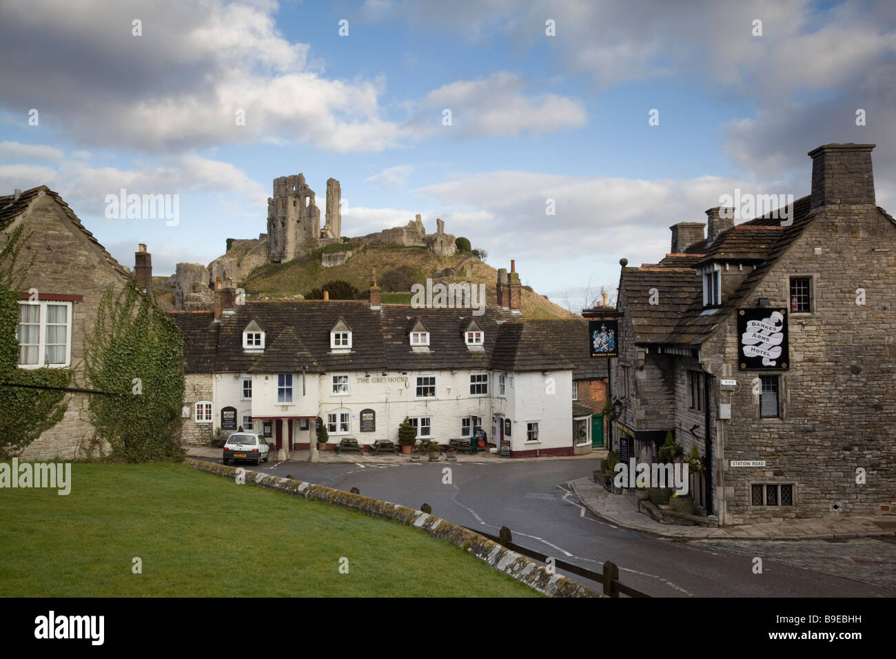 The ruin of Corfe Castle towers over the village through which all traffic for Swanage has to pass Stock Photo