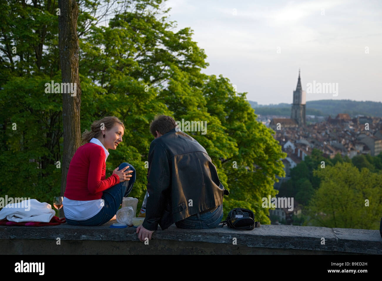 Couple sitting on a wall while enjoying a picnic Rosengarten Berne Canton of Berne Switzerland Stock Photo