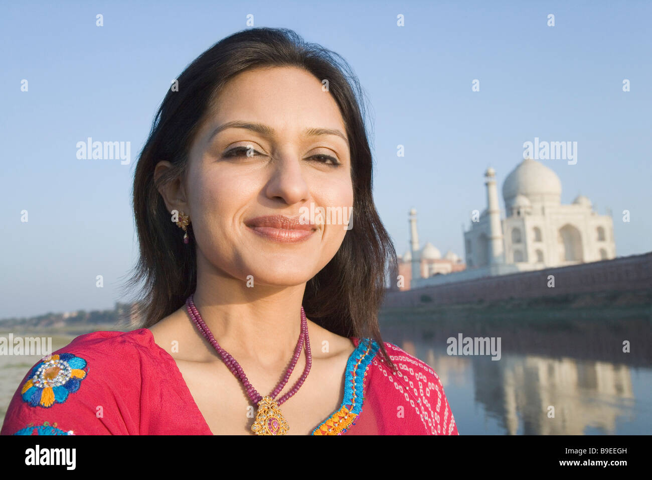 Portrait of a woman with a mausoleum in the background, Taj Mahal, Agra, Uttar Pradesh, India Stock Photo