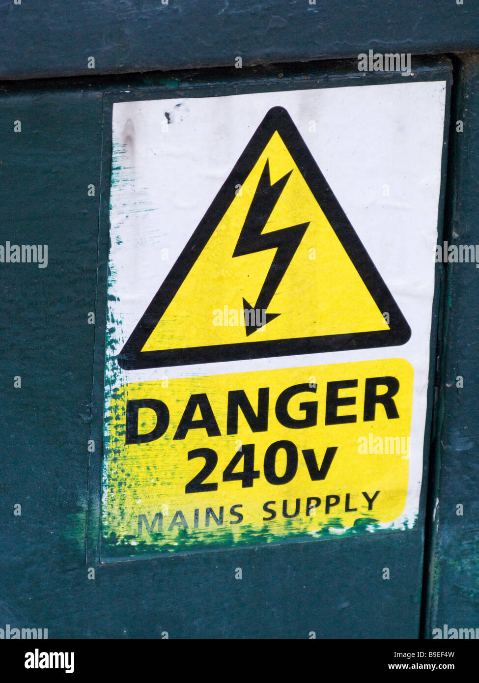 'Danger 240 volts' sign on a Virgin Media cable TV / broadband connection junction box in the street. Stock Photo