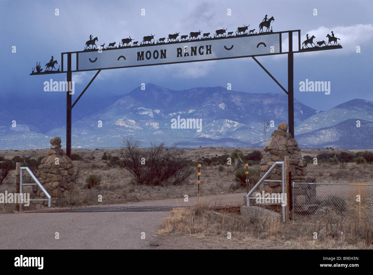 Wrought iron ranch gate near Buckhorn in Grant County Mogollon Mtns in distance New Mexico USA Stock Photo