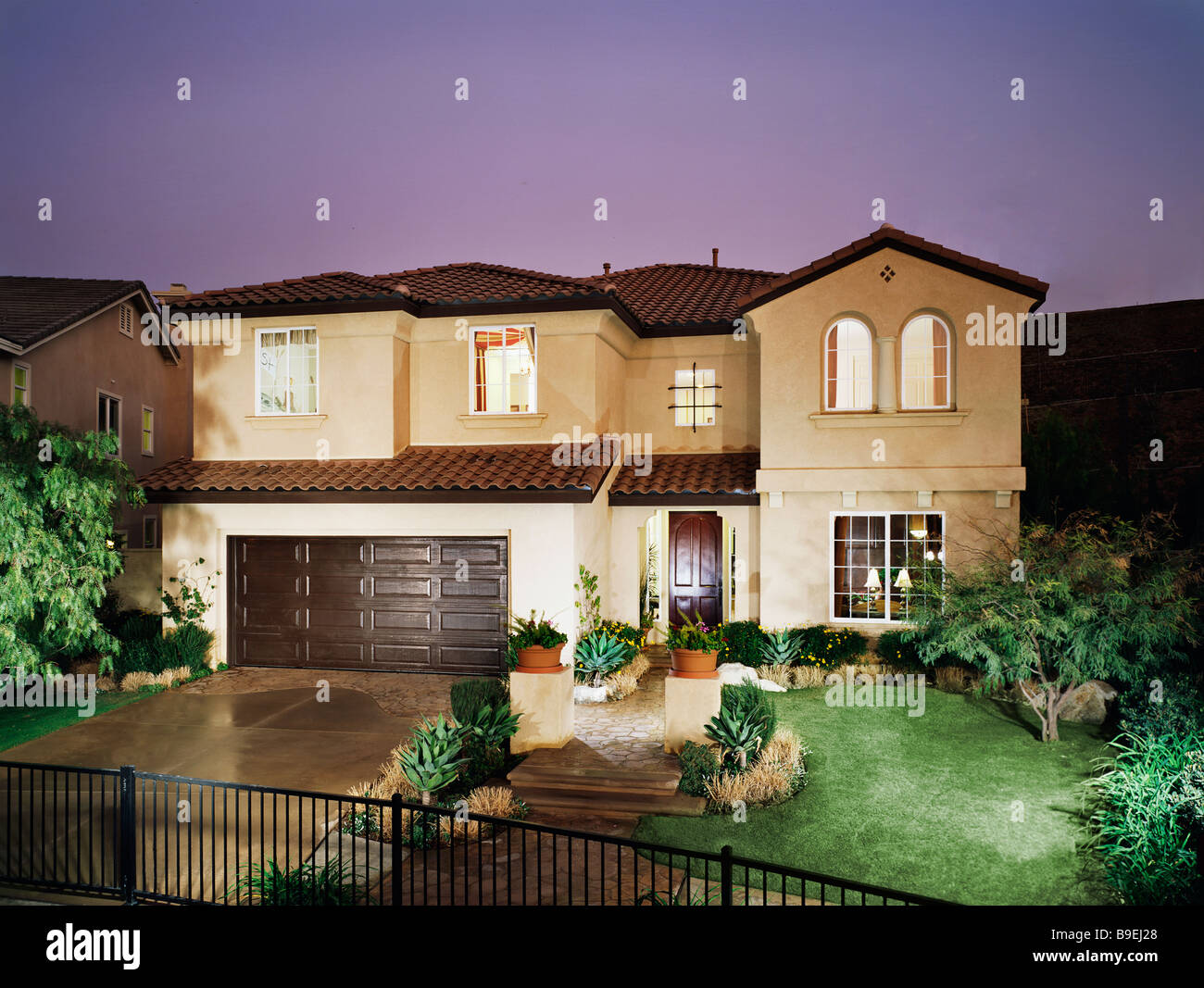Front exterior multiple story spanish style home Stock Photo
