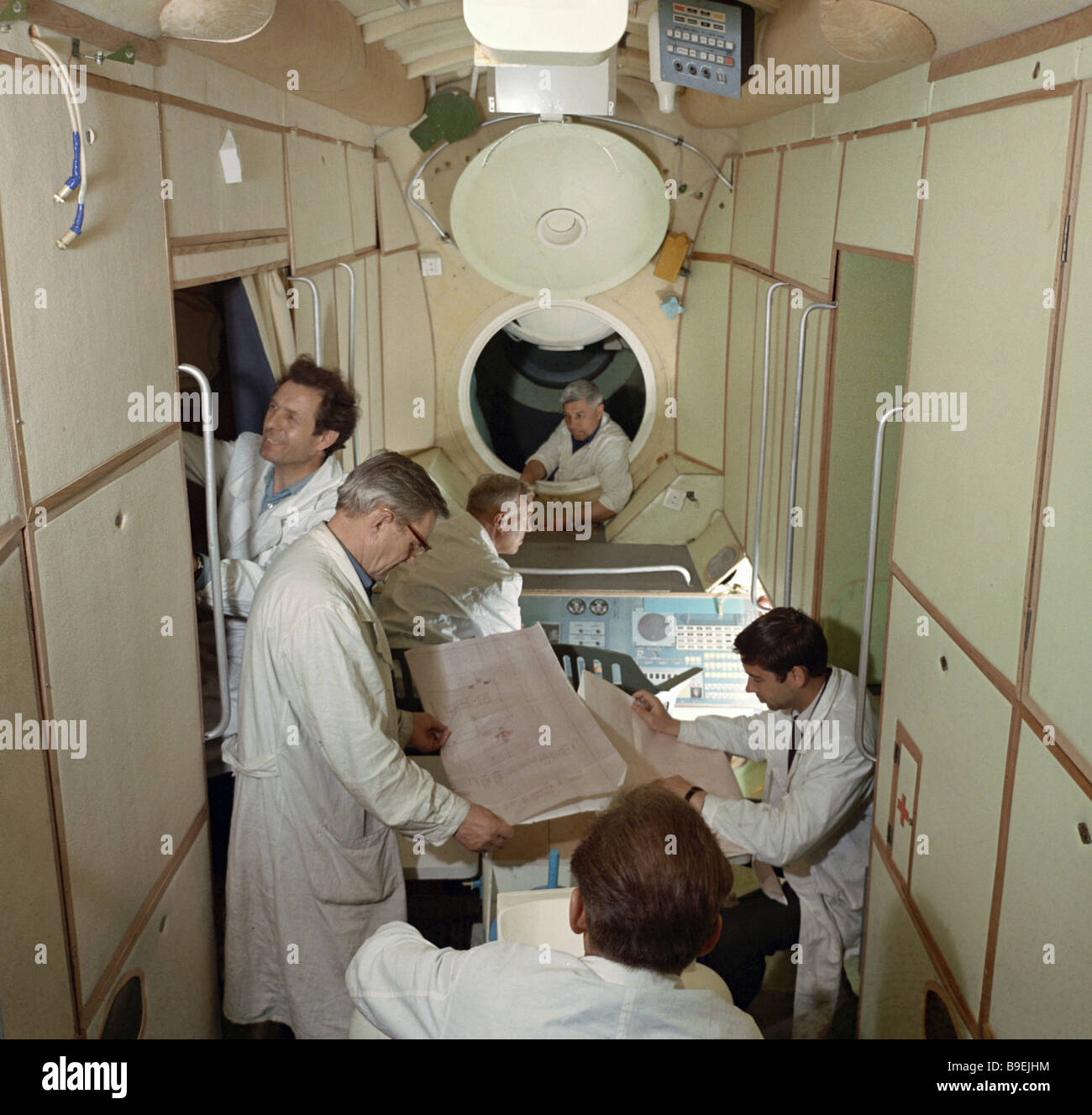 Engineers and assemblymen working inside the Salyut station Stock Photo ...