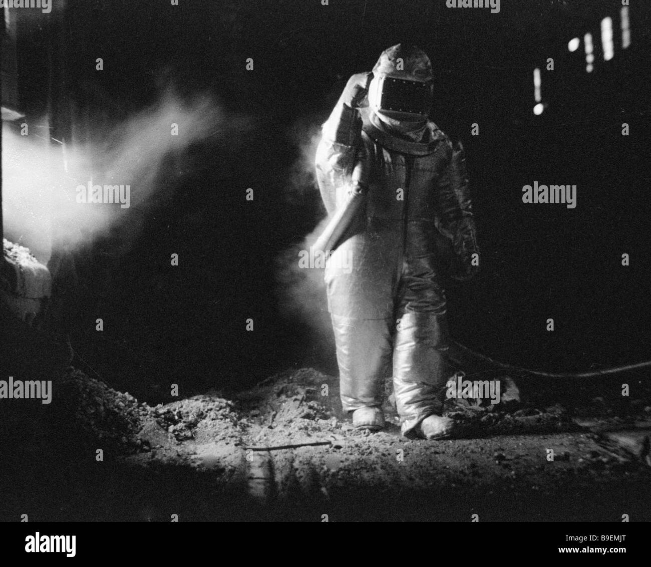 Test engineer wearing an exposure suit that allows metallurgists to ...