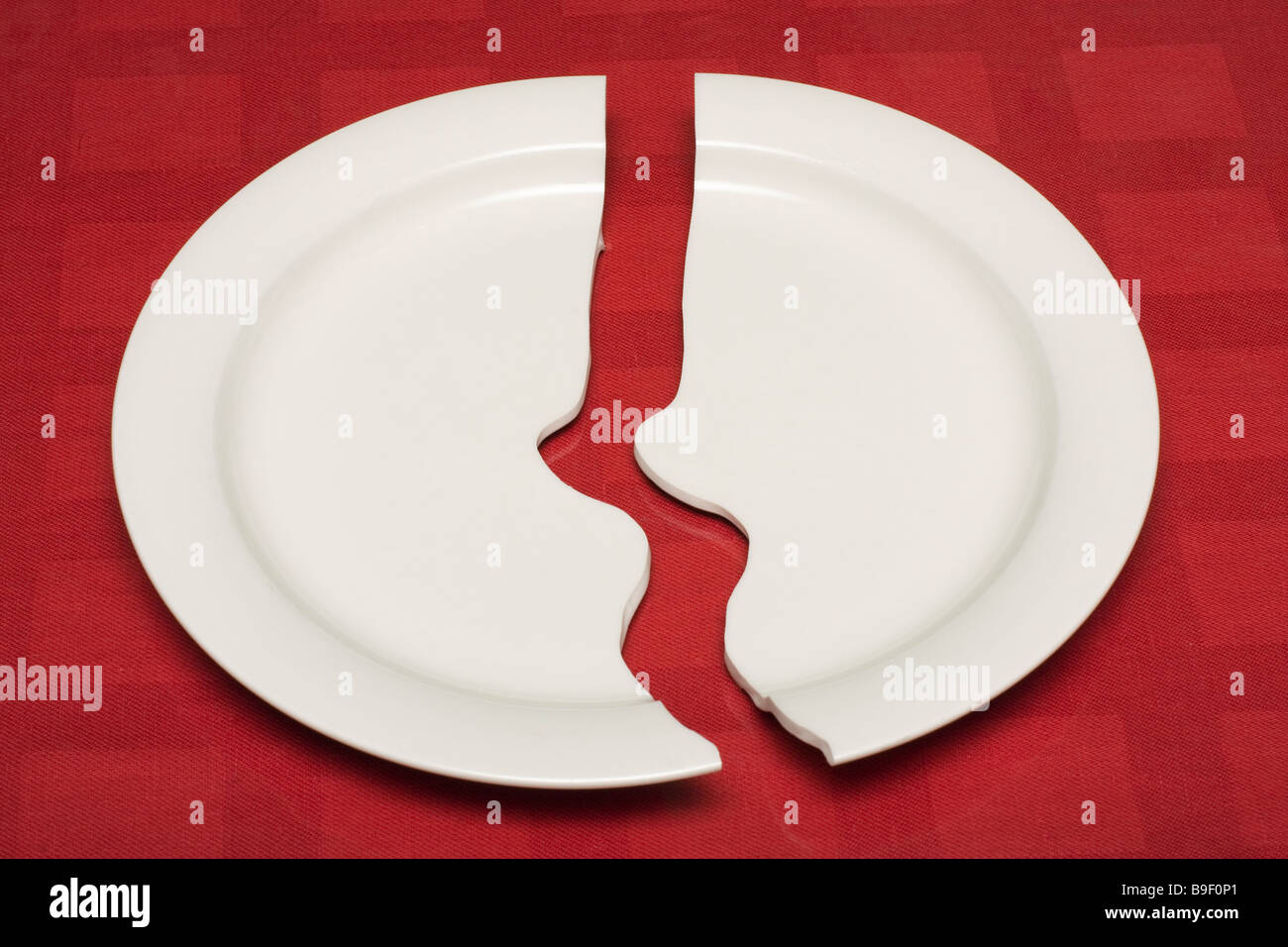 A white porcelain plate broken in two halves Stock Photo