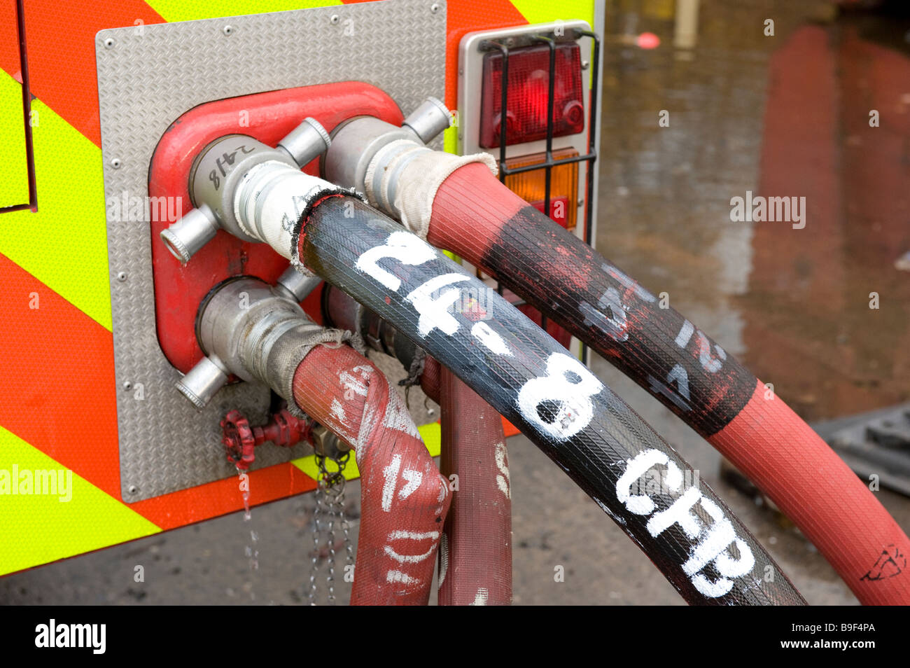 4 fire hoses connected to fire brigade Hydraulic Platform inlet manifold Stock Photo