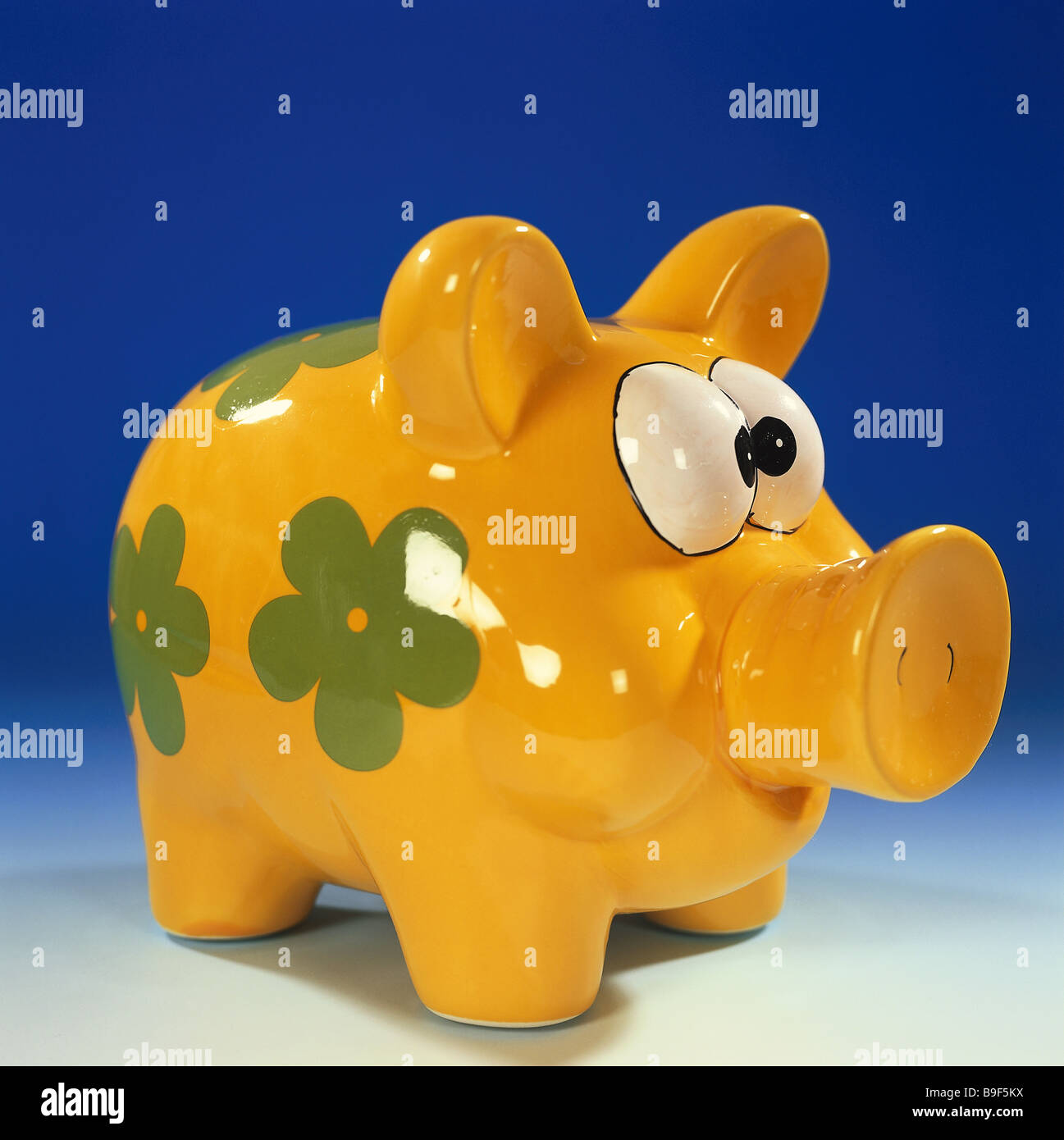 saving-pig yellow little flower paints saving-can animal-form ceramics-pig pig saves finances provision future-planning Stock Photo