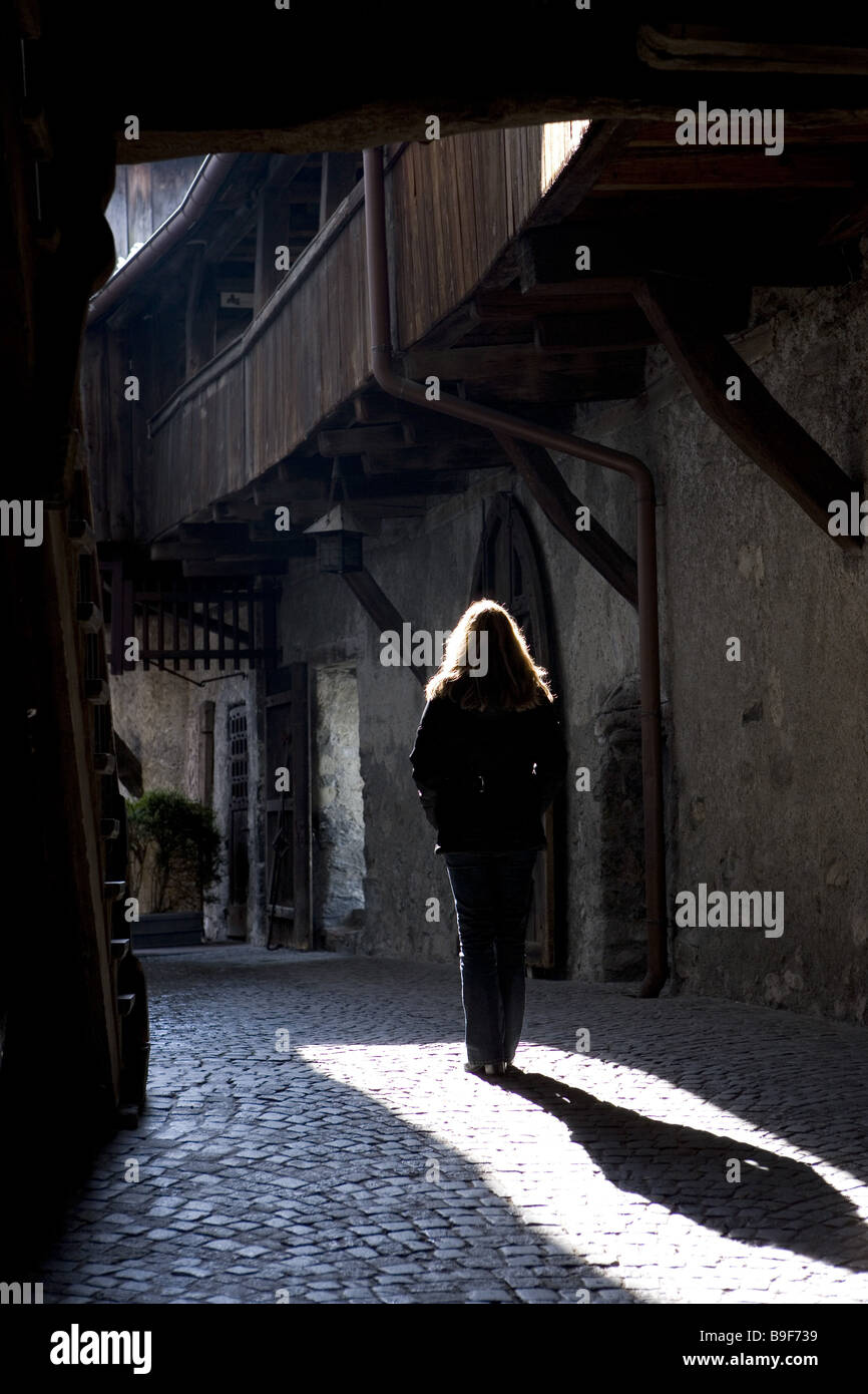 Austria Vorarlberg Feldkirch shadow-castle castle inner ward woman back view light shadows Stock Photo
