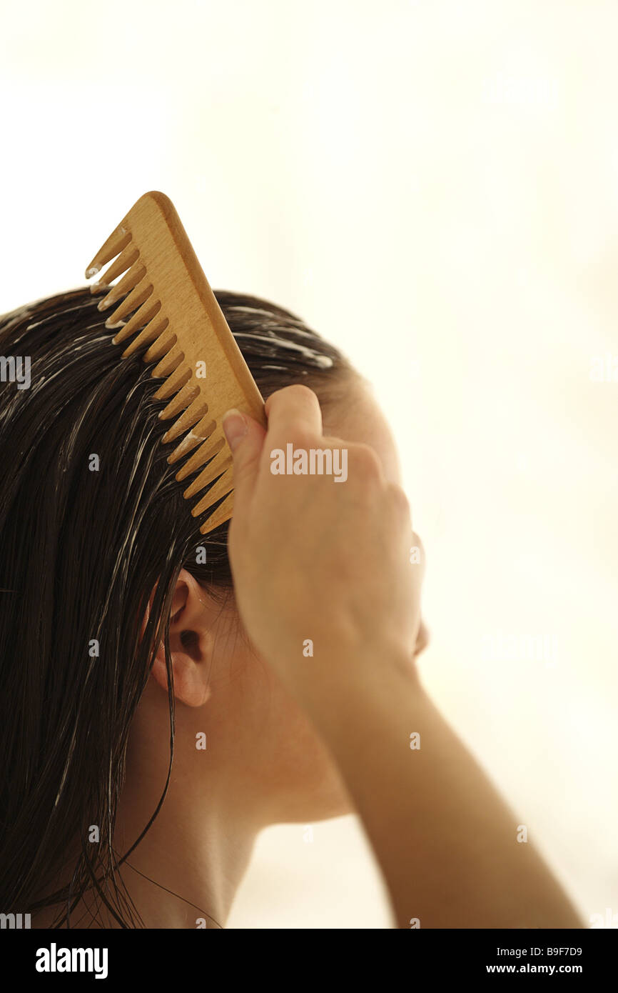 Woman hair care cure is too bulky strand-comb side-portrait series broached people young residence time hair wet cure-packet Stock Photo