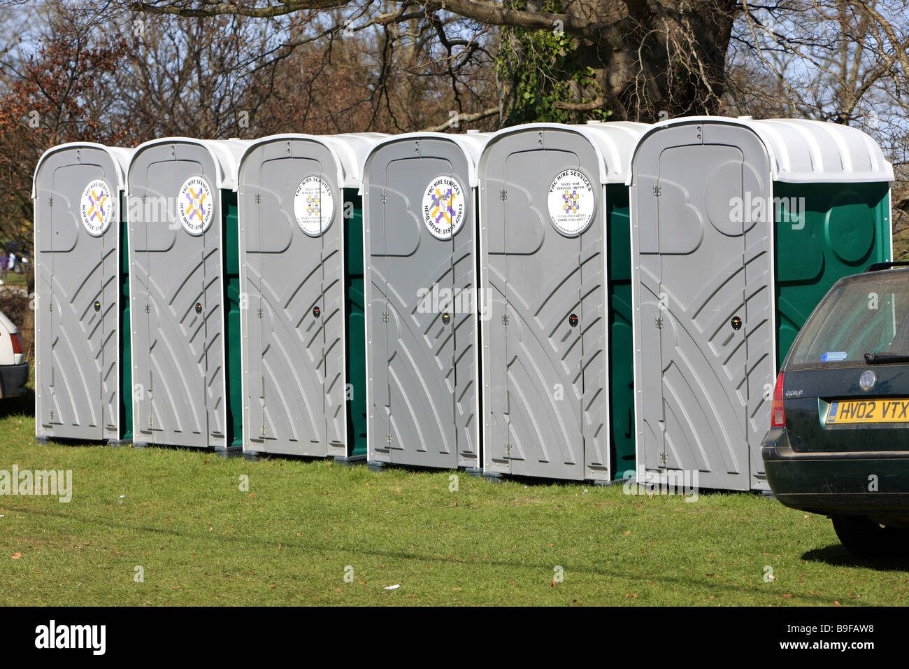 A row of portable loos or potty toilets at an outside event Stock Photo