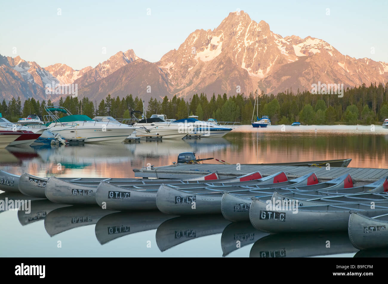 First light after sunrise paints Mount Moran and the surface of Jackson