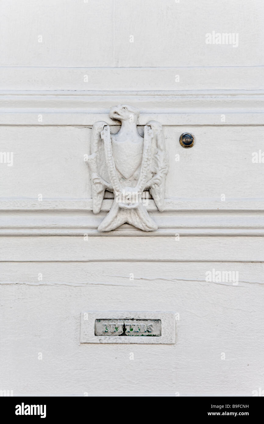 white door with door knocker, spy hole and letter box Stock Photo