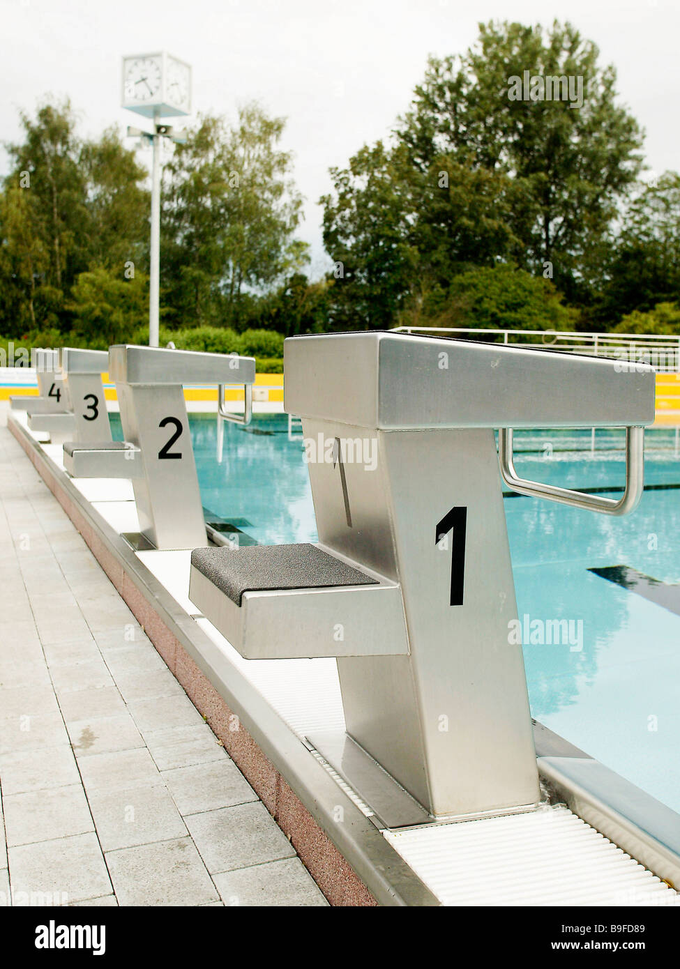 Swimming starting blocks at poolside Stock Photo