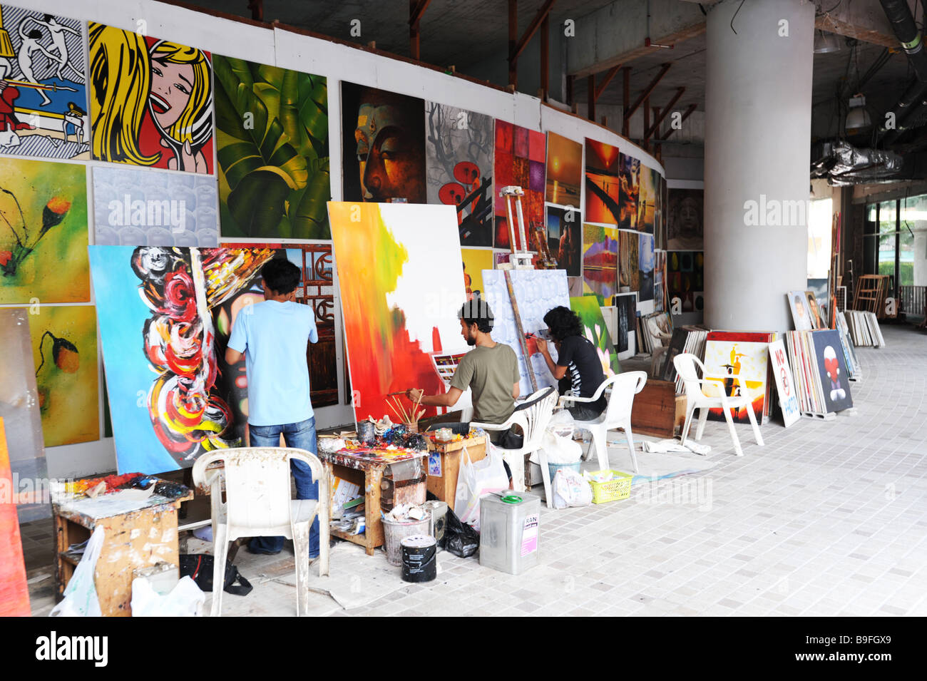 Artists working on tourist paintings in a shopping mall in Patong Beach, Phuket Thailand Stock Photo