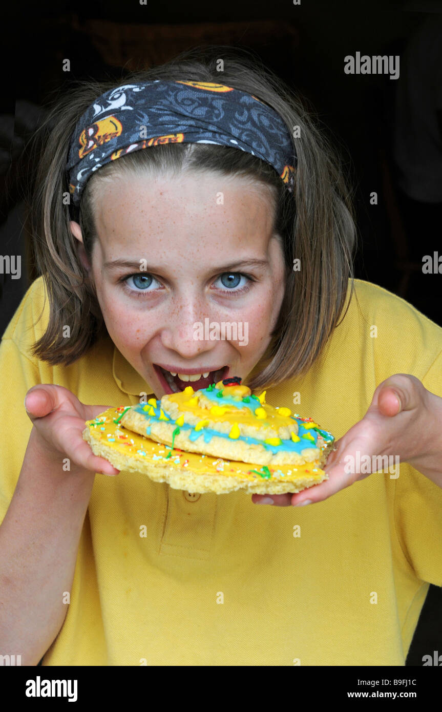 close up portrait of girl eating biscuit Stock Photo