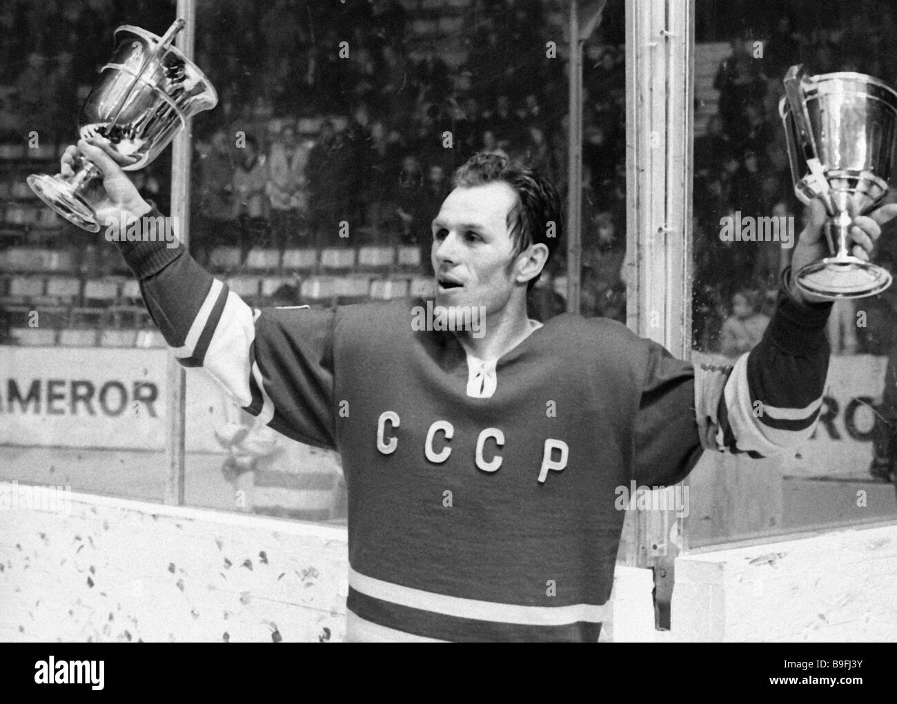 Soviet national ice hockey team captain Vyacheslav Starshinov holds the