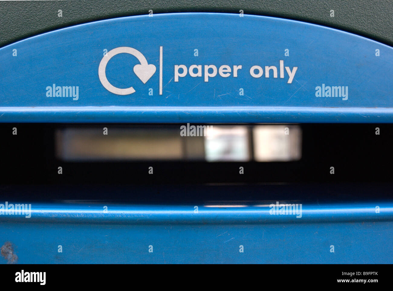 opening in paper recycling bin, surbiton, surrey, england Stock Photo