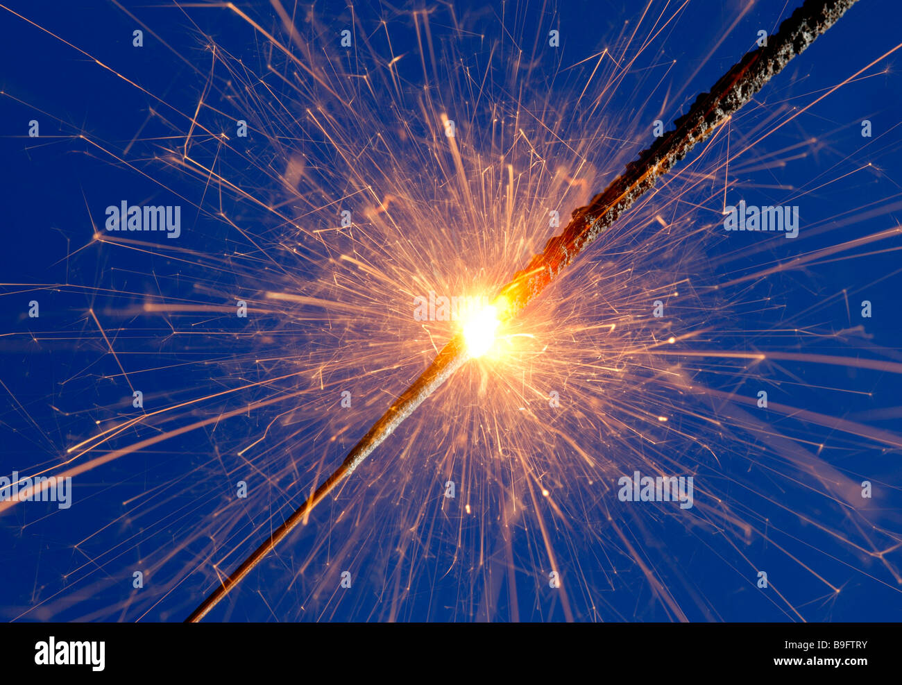 sparkler against blue background Stock Photo
