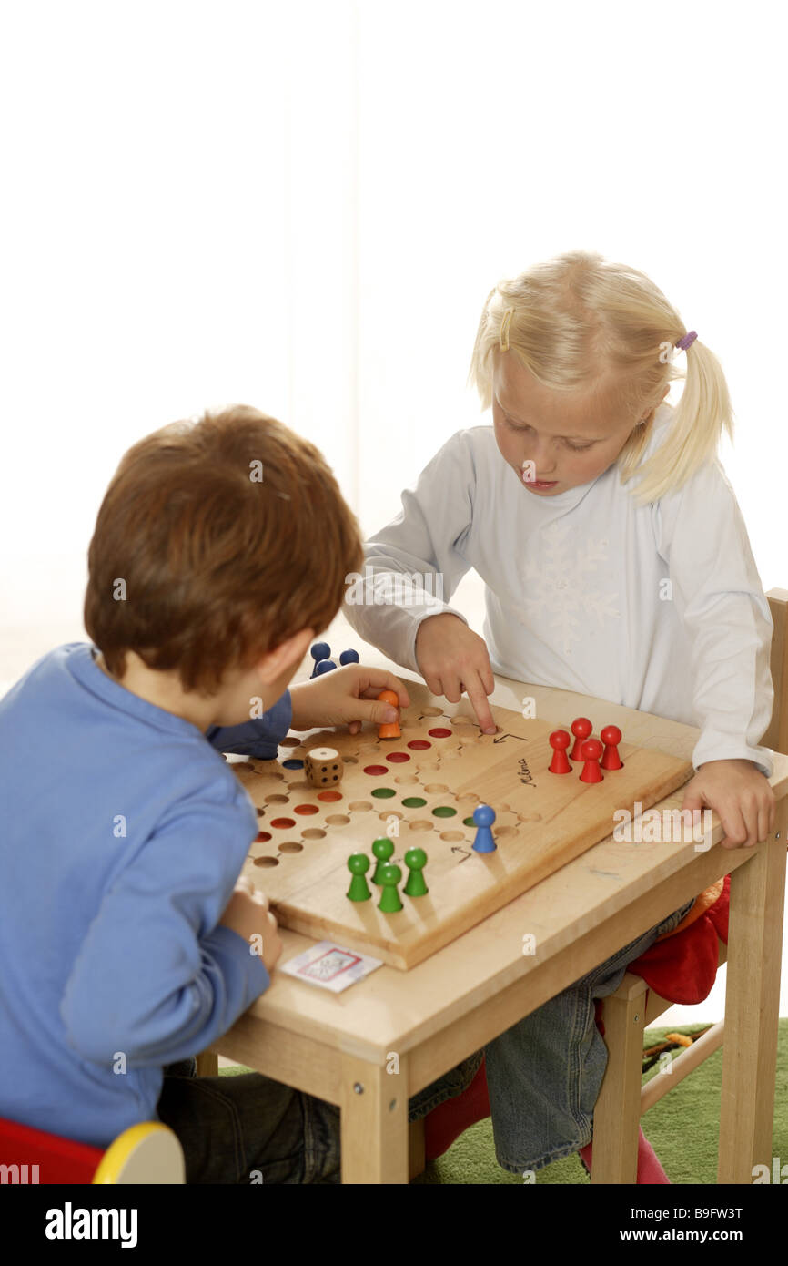 girl boy ludo plays detail series people children board-game game dice wooden dice cheerfully fun enjoyments together siblings Stock Photo