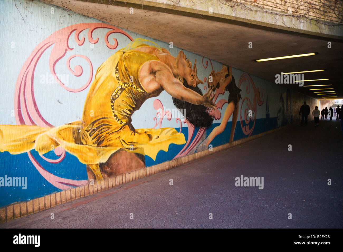 A mural depicting contemporary dance painted on the wall of the pedestrian underpass.  Weymouth seafront. Dorset. UK. Stock Photo