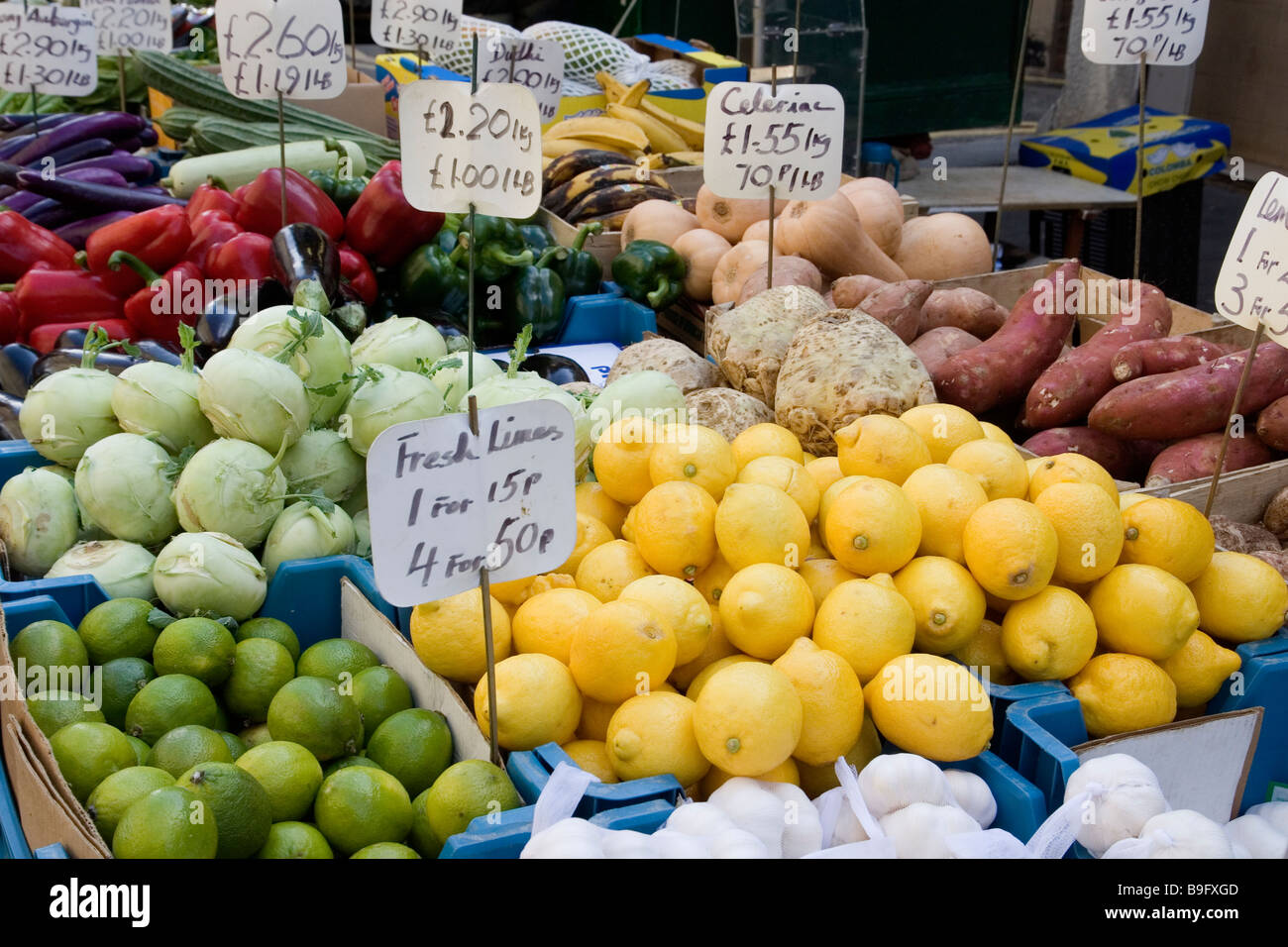 Chinese market trader selling produce in Surrey street market Croydon Surrey Stock Photo