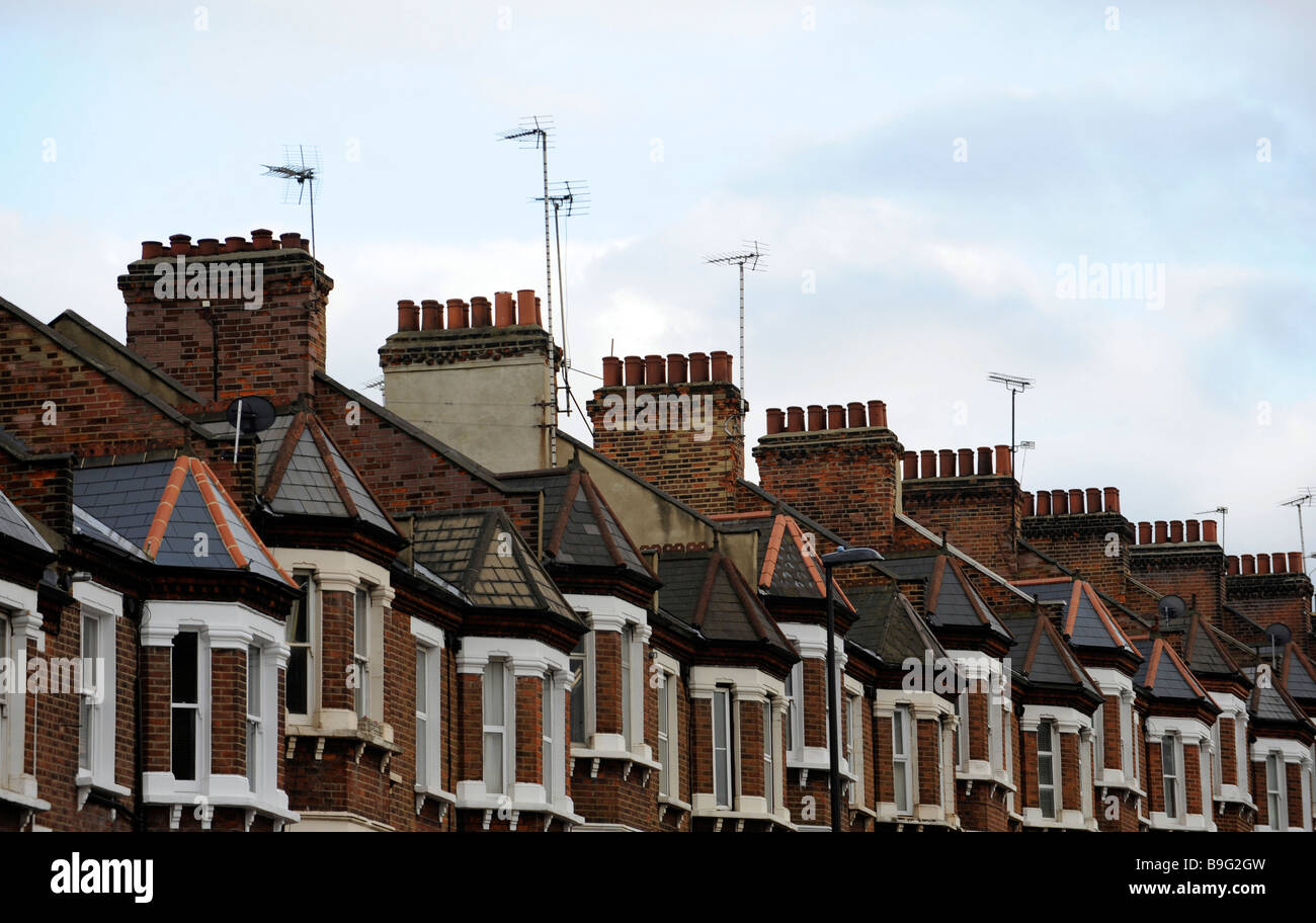 A row of chimneys atop maisonettes, flats, housing, in London, England, during the credit crunch, housing slump, economic crisis Stock Photo