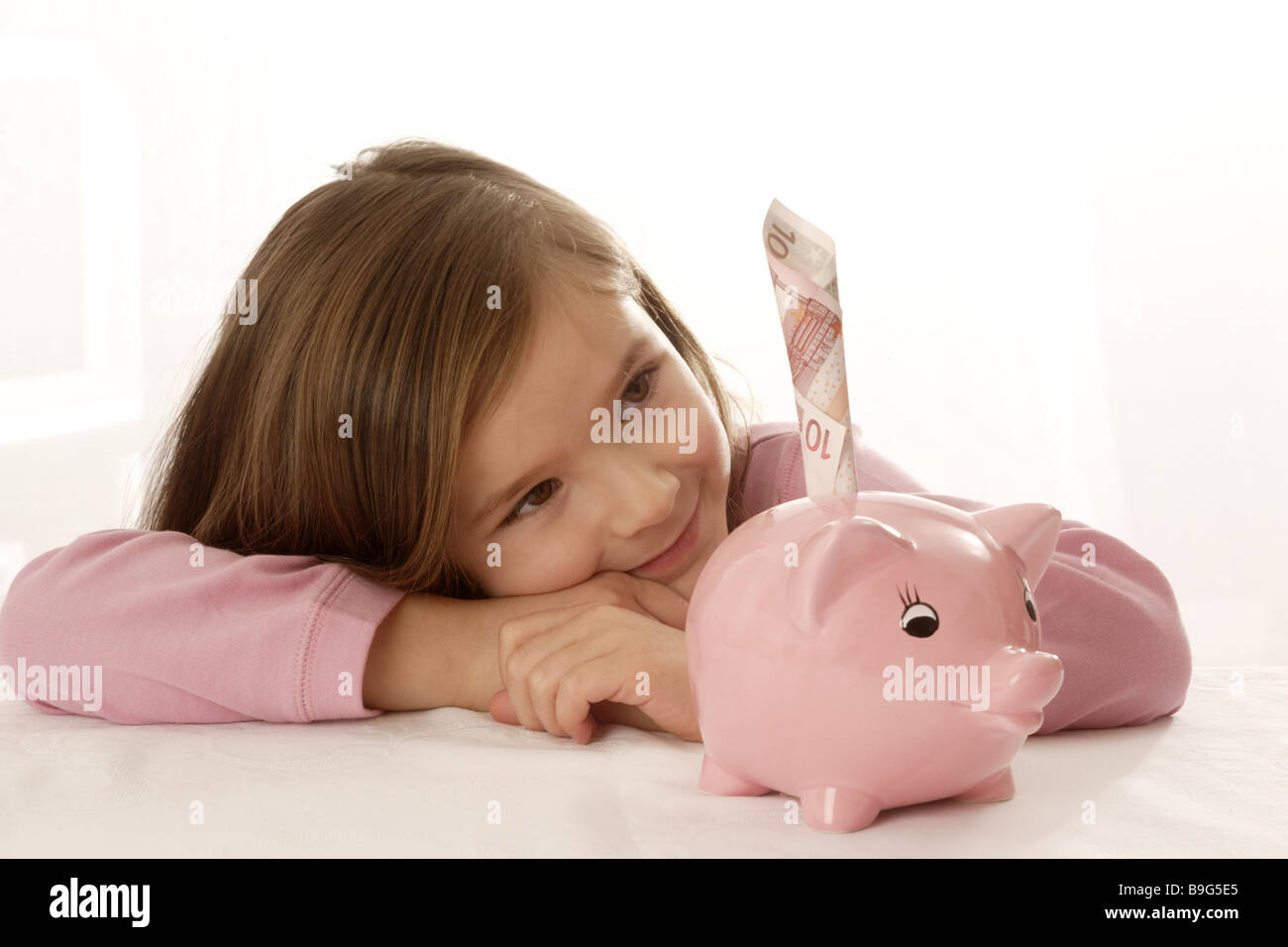 6-8 years old-age-provision interjecting saving finances money investment bill happily household-cash register inner child Stock Photo