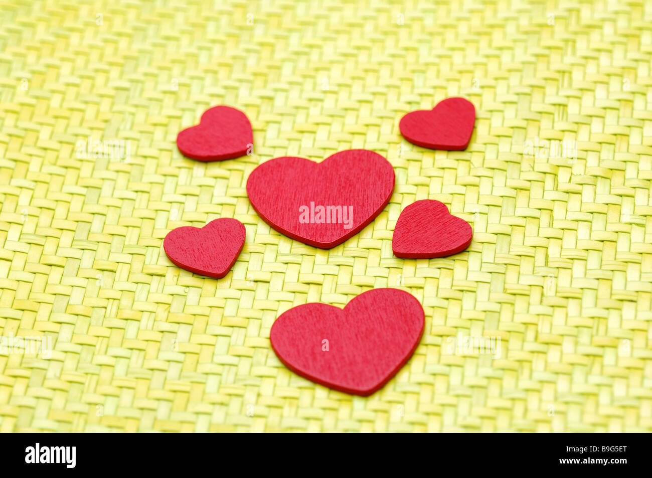 Bast-mat yellow wood-hearts red decoration-articles decoration-articles hearts symbol love affection love-symbol cordiality Stock Photo
