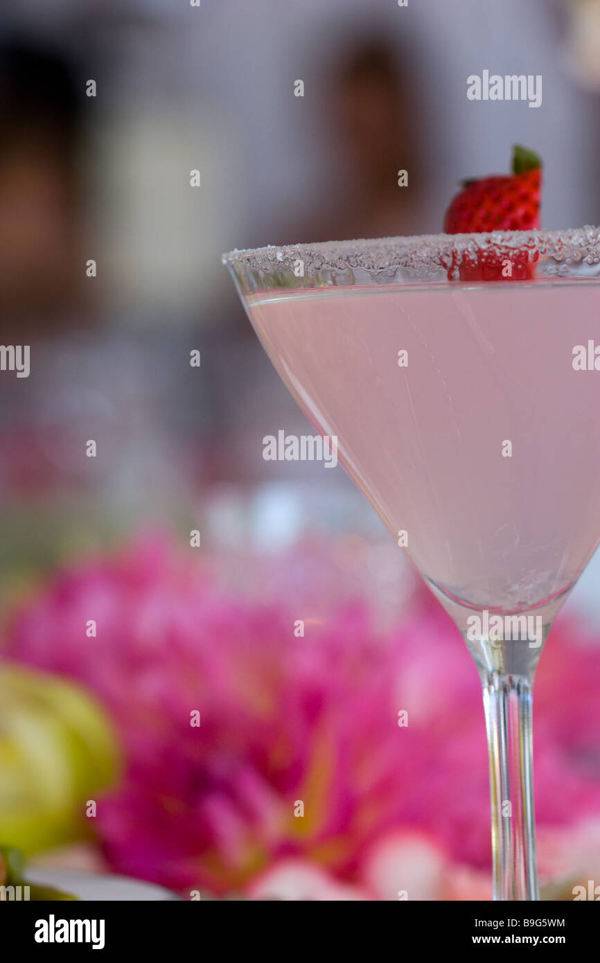 wedding cocktail - pink martini with strawberry and sugar rim - coordinated with wedding colors Stock Photo