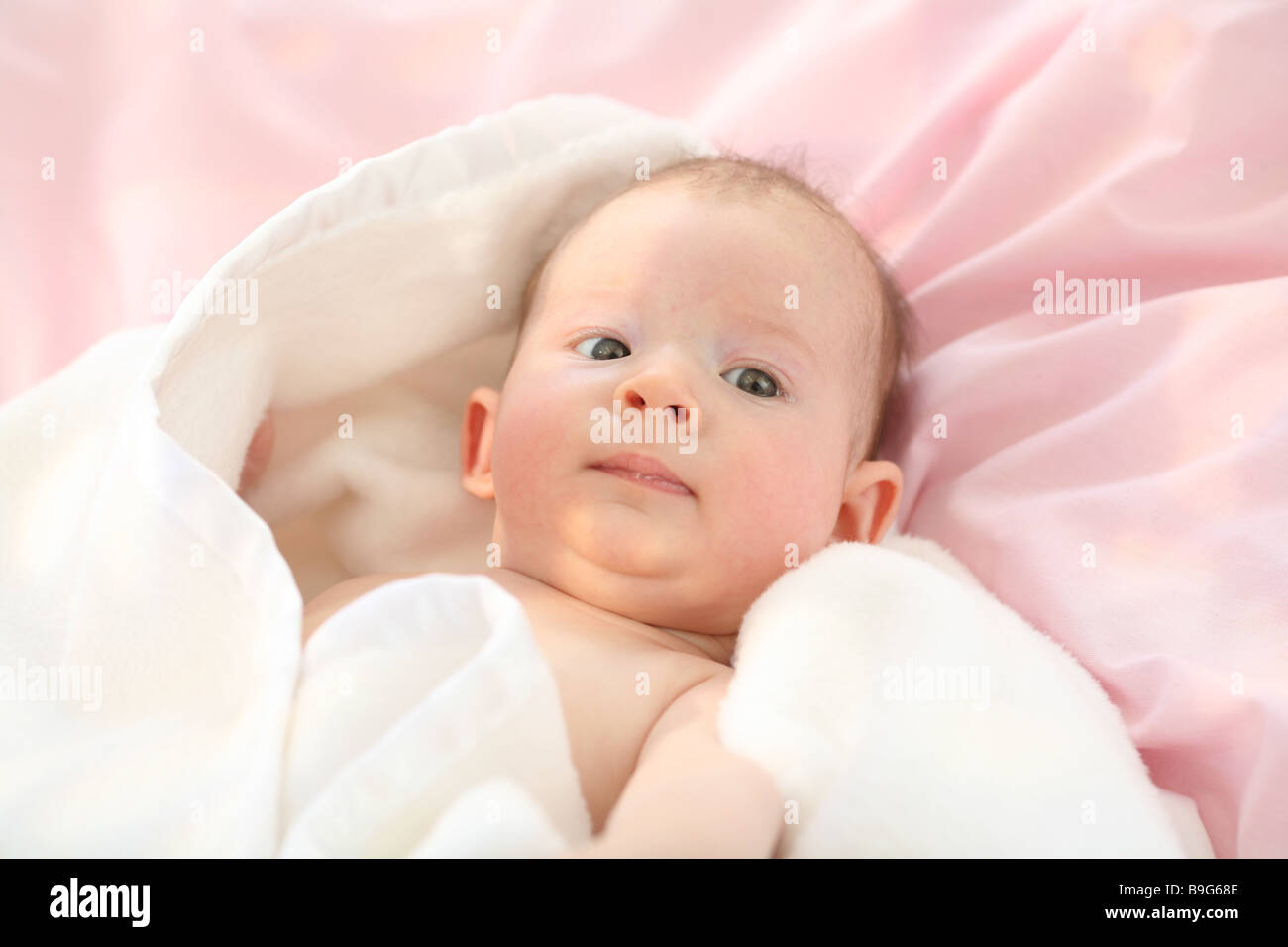 Baby lying supine position blankets portrait enveloped 3 months resting