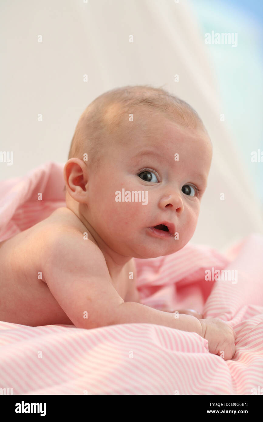 Baby lying prone position head portrait lifts 4 months wakened resting