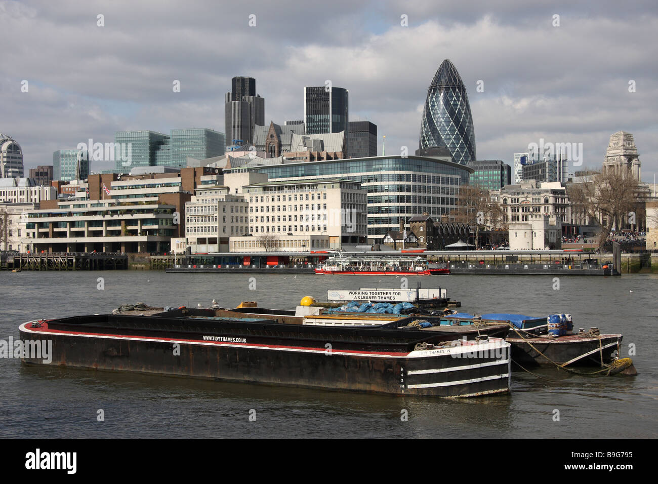 london england uk barge gherkin natwest tower modern glass clad offices architecture river thames Stock Photo