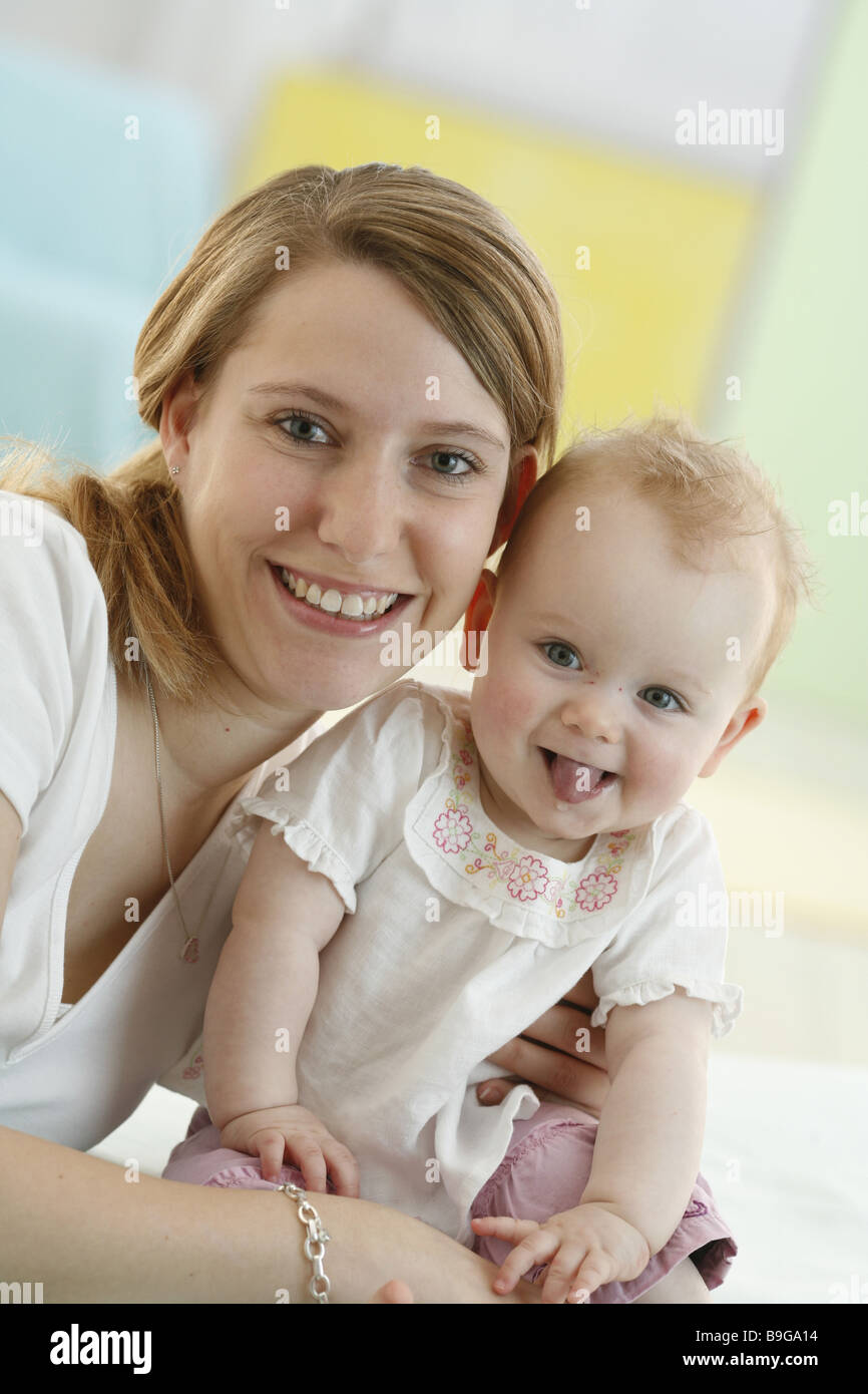 Mother baby smiling facial expression tongue mouth portrait 20-30 years 8 months attention baby gaze camera woman joy pleasing Stock Photo
