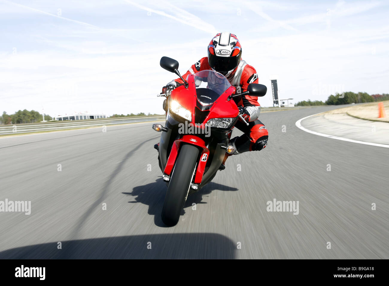 Racetrack curve motorcyclists streets people man motorcycle drives