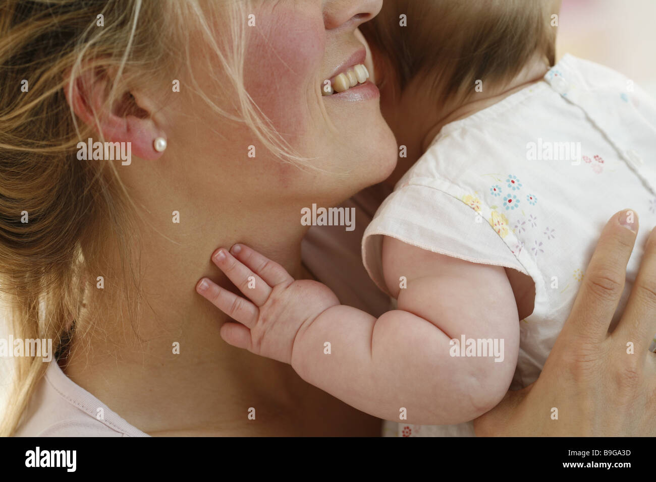 Mother baby embraces smiling baby-hand portrait excerpt close-up  20-30 years 5 months broached attention excerpt baby Stock Photo