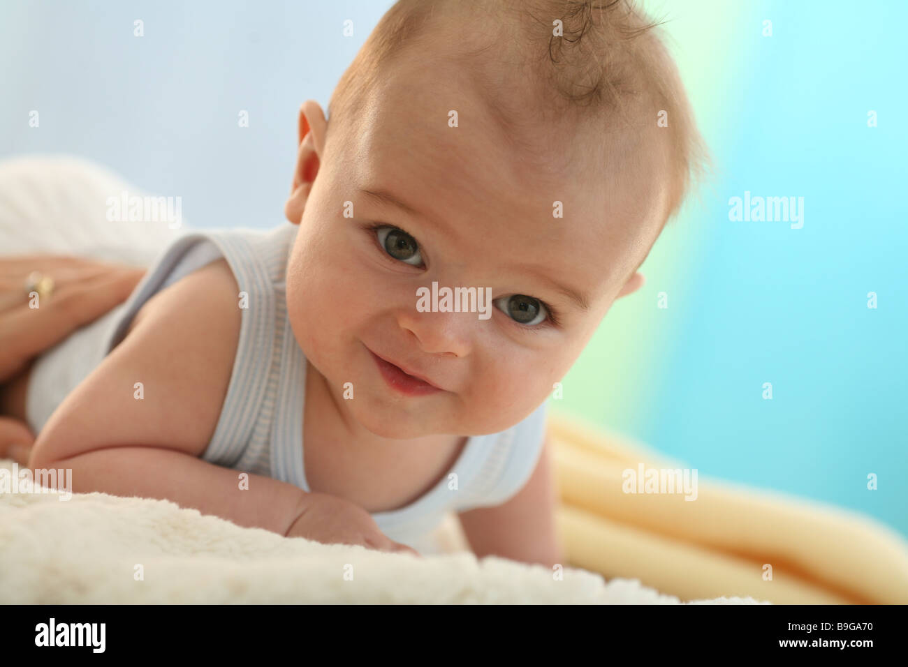 Baby lying prone position poor rest head portrait lifts 5 months poor rest wakened alertly baby prone position gaze camera one Stock Photo