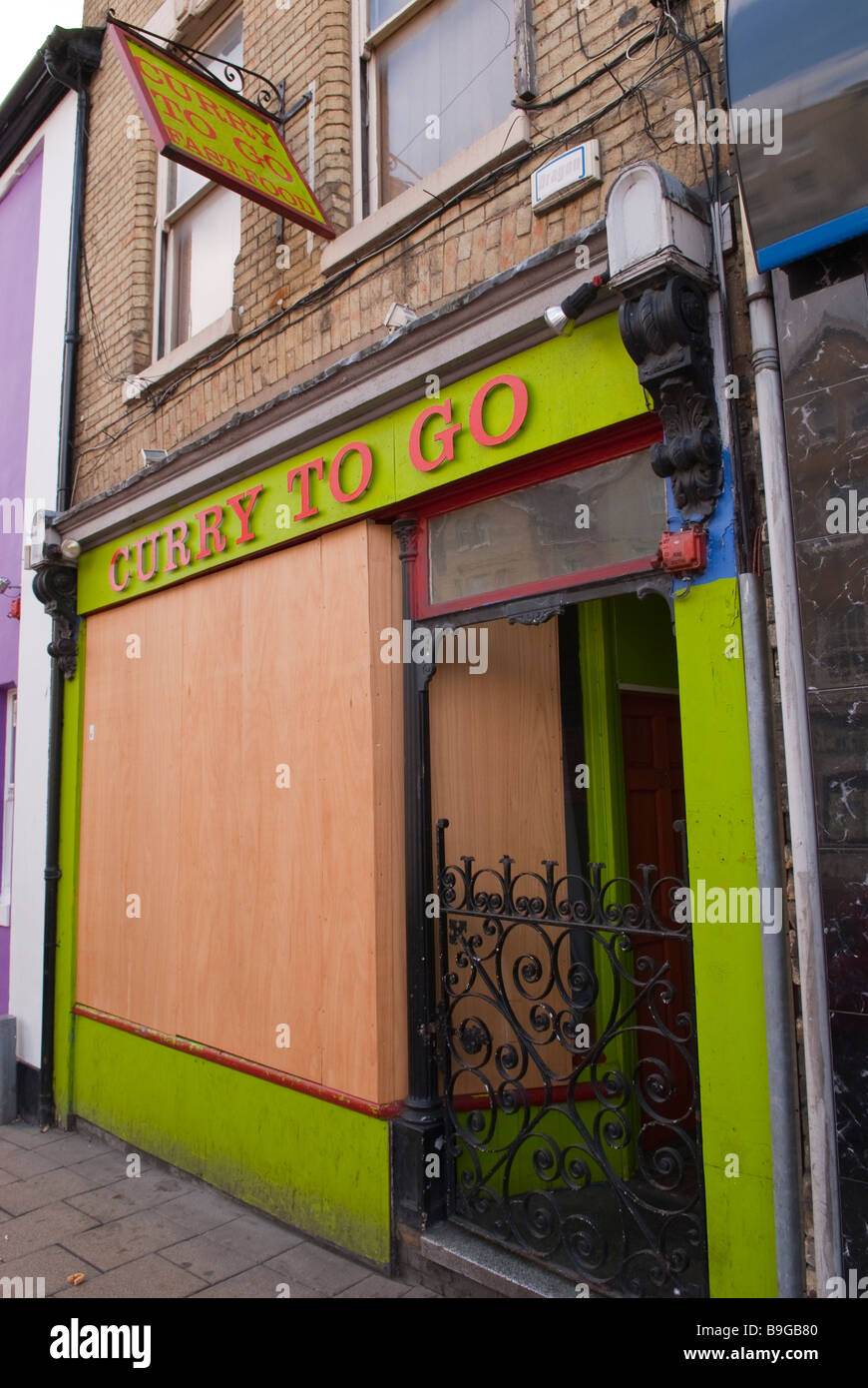 Curry to go indian take away shop store boarded up and GONE in Norwich,Norfolk,Uk Stock Photo