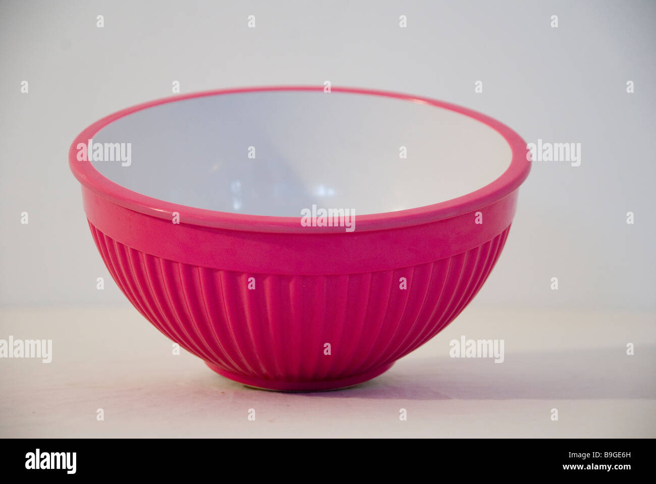 Pink and white food mixing bowl on a white background with soft shadow Stock Photo