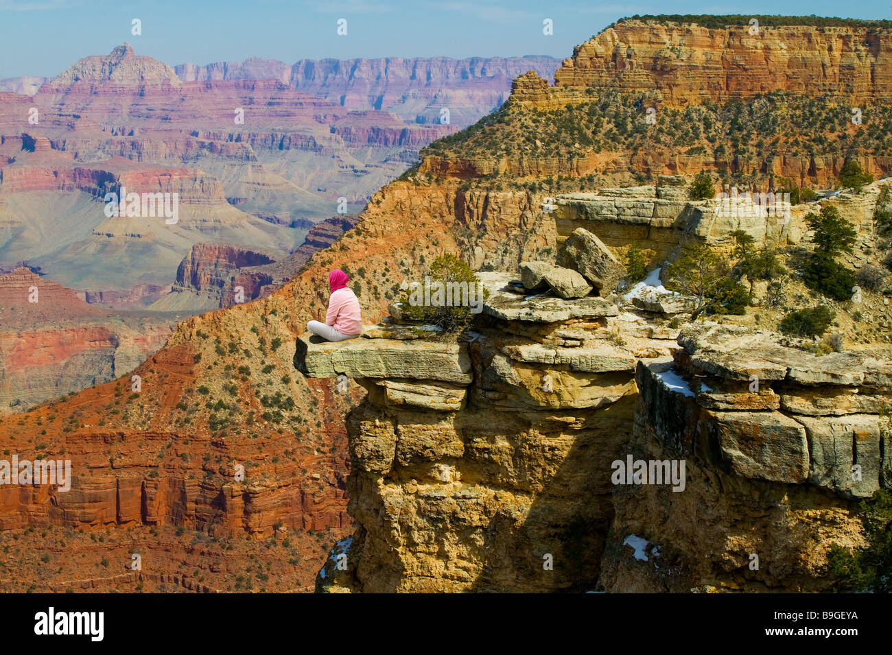 Woman sitting on Ledge Grand Canyon Stock Photo - Alamy