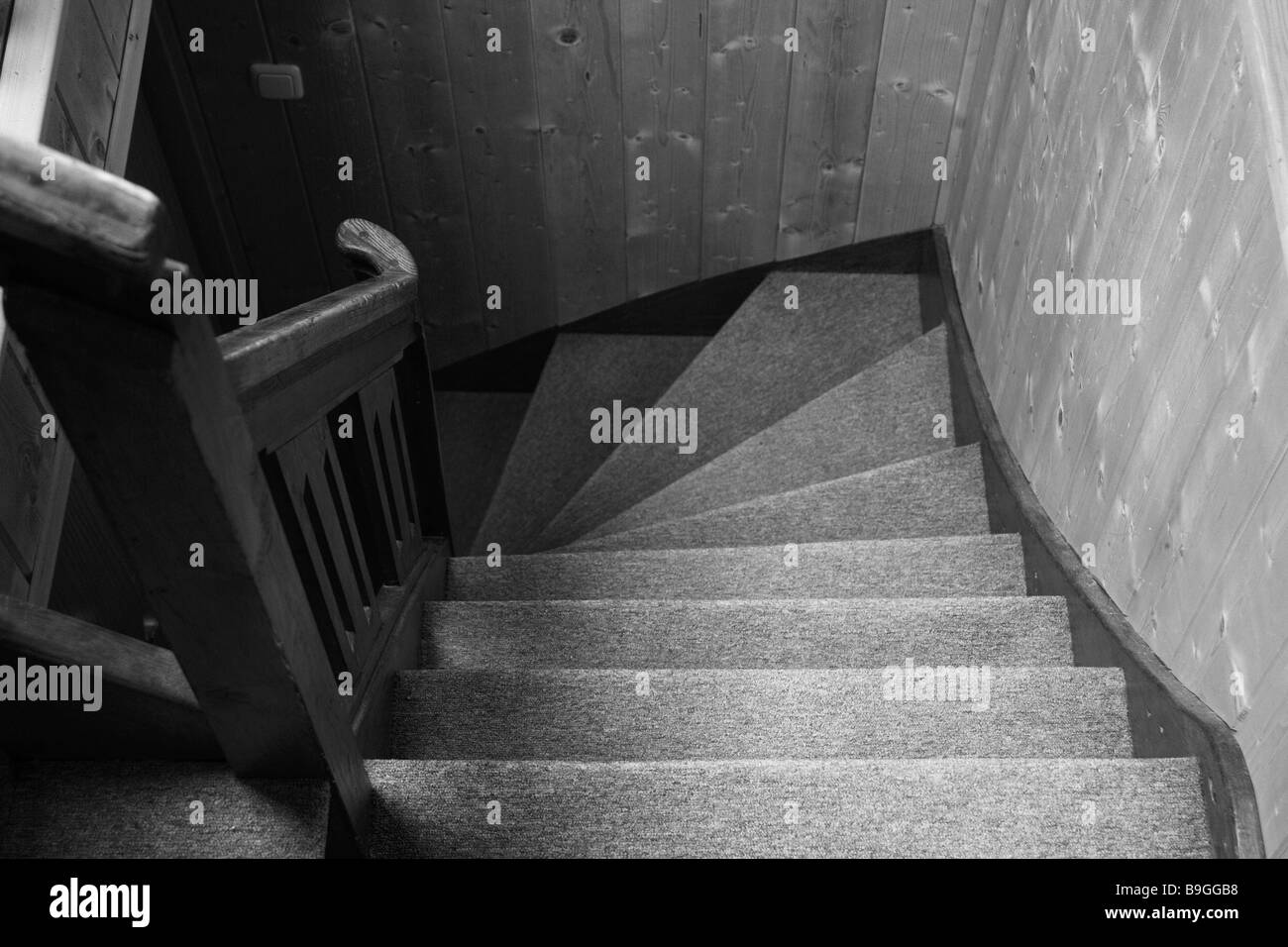 Apartment stairway s/w steps hand-rails wood-hand-rails banisters wood-wall wood-panelling indoors stairway-ascent ascent Stock Photo