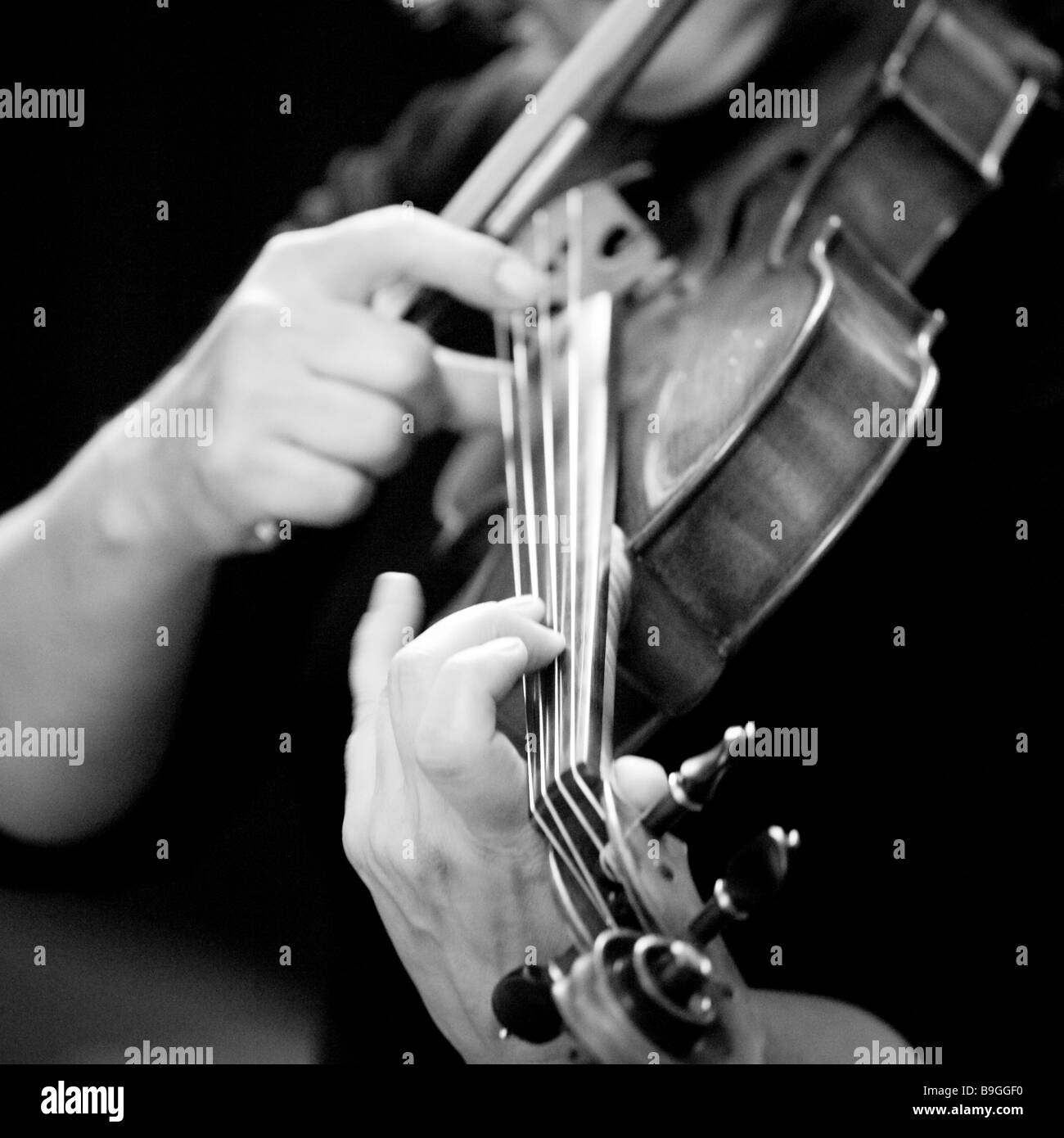 Plucking a guitar or a violin strings Black and White Stock Photos
