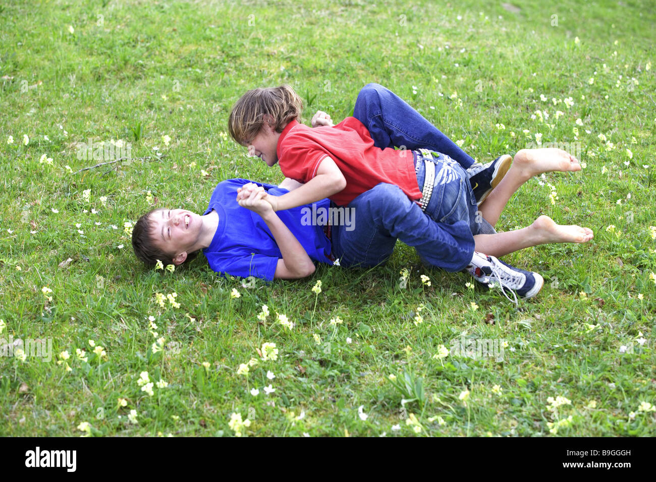 11-13 years fight meadow boys people children two childhood friends enemies dispute wrangling fight rolls full-length rivals Stock Photo