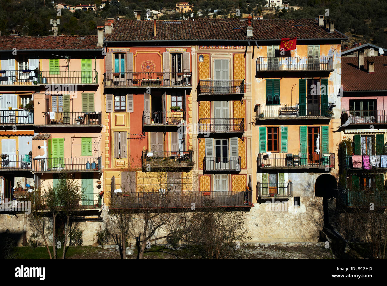 houses on river bank, Sospel, France Stock Photo