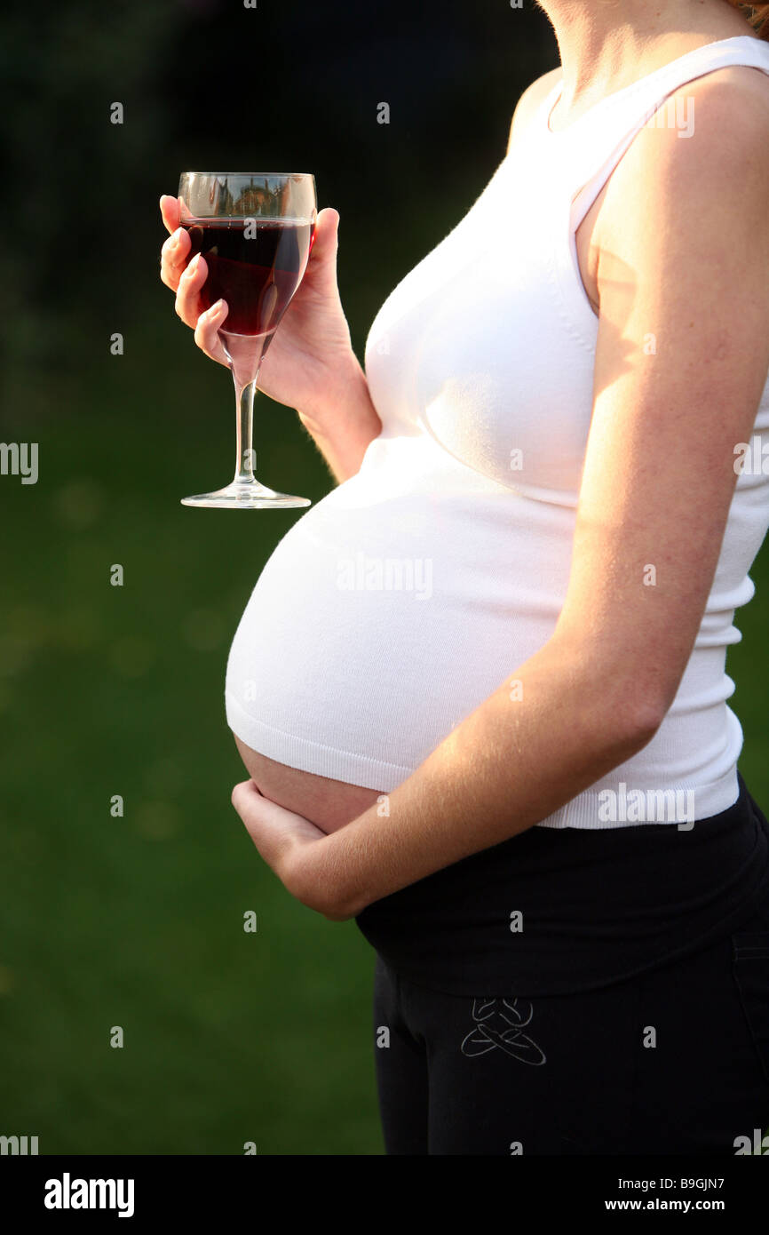 A pregnant woman with a glass of red wine Stock Photo Alamy