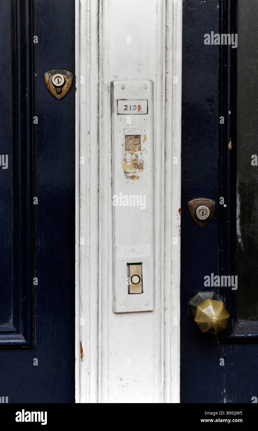 Two front doors to city flats, side by side with locks and door bells, buzzers Stock Photo