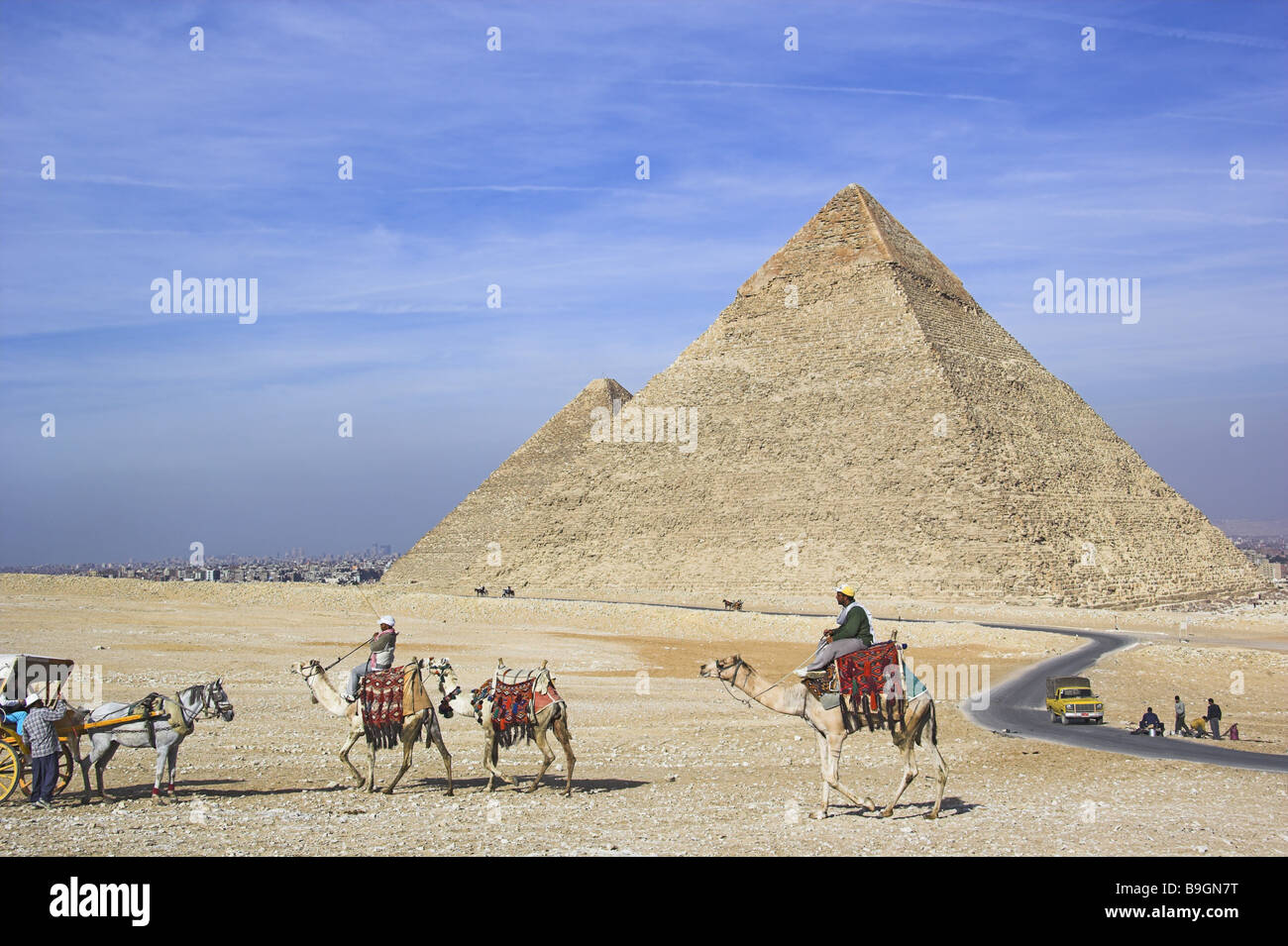 Egypt Cairo Giseh pyramids rding a camel Antiquity architecture trip destination style constructions sightseeing boss-reintag Stock Photo