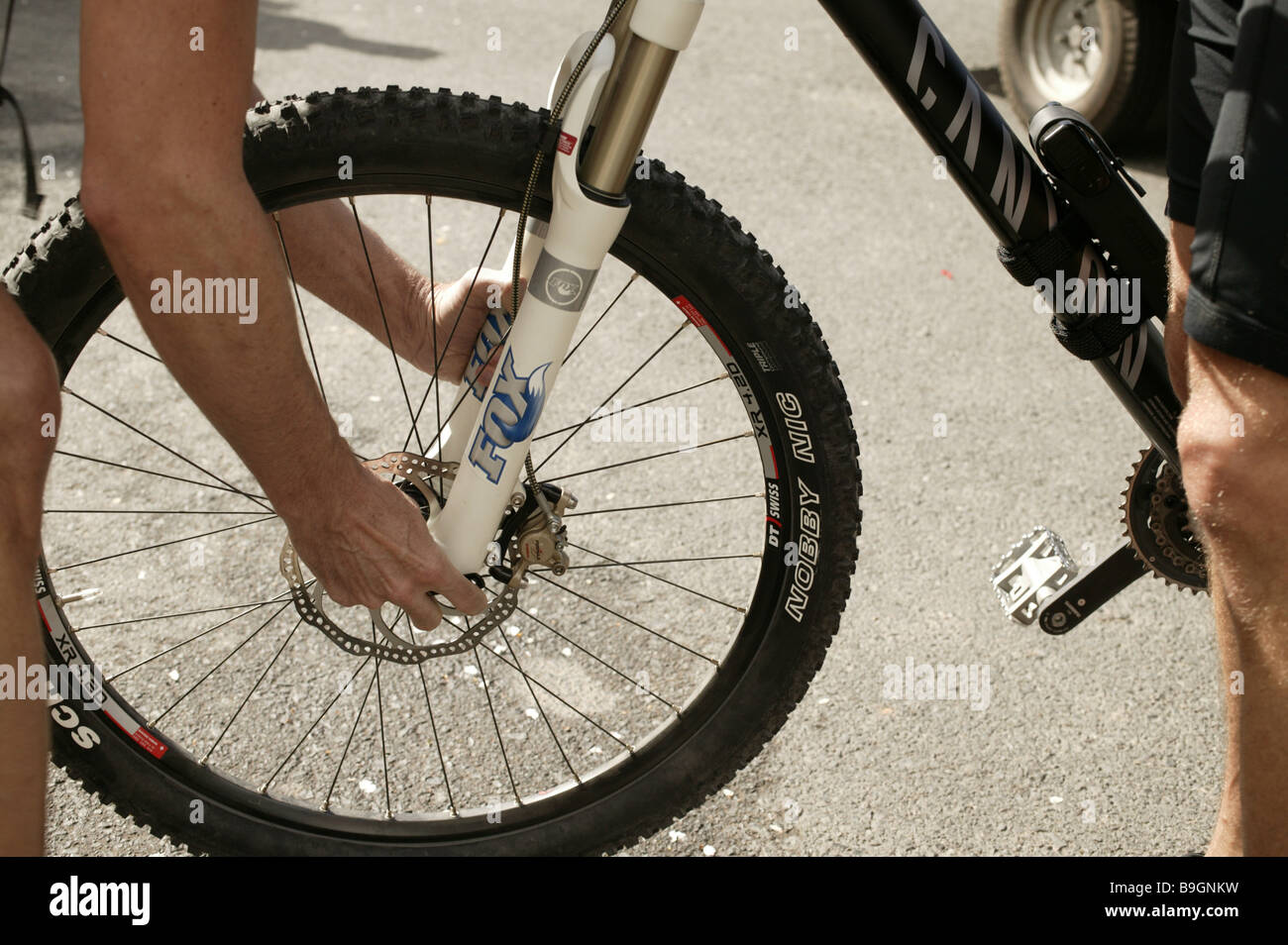 Man hands frontwheel installs tires mountainbike Actively activity